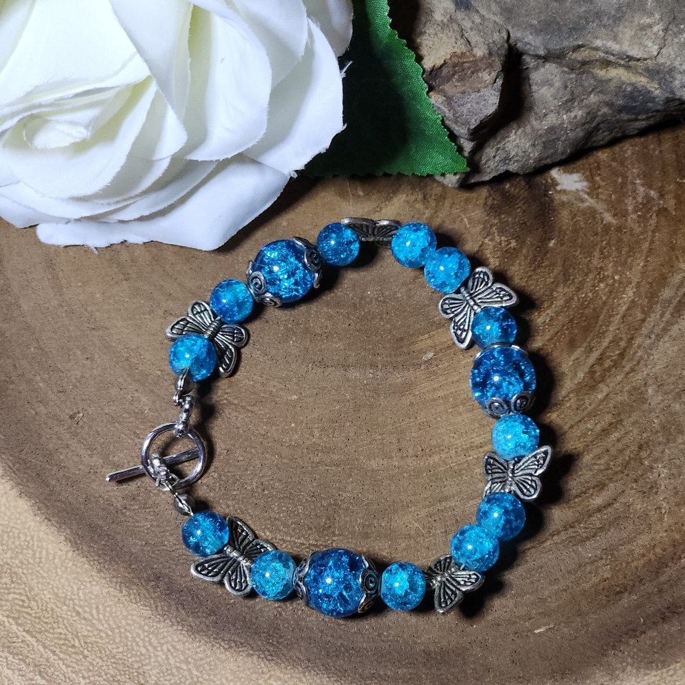 Bracelet With Ocean Blue Crackled Glass Beads And Silver Toned Butterflies